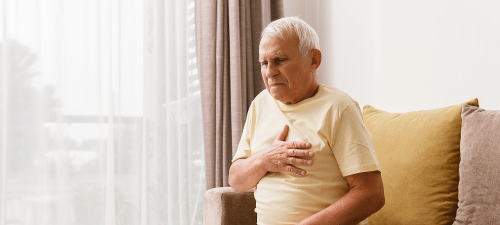 man with acid reflux holding chest